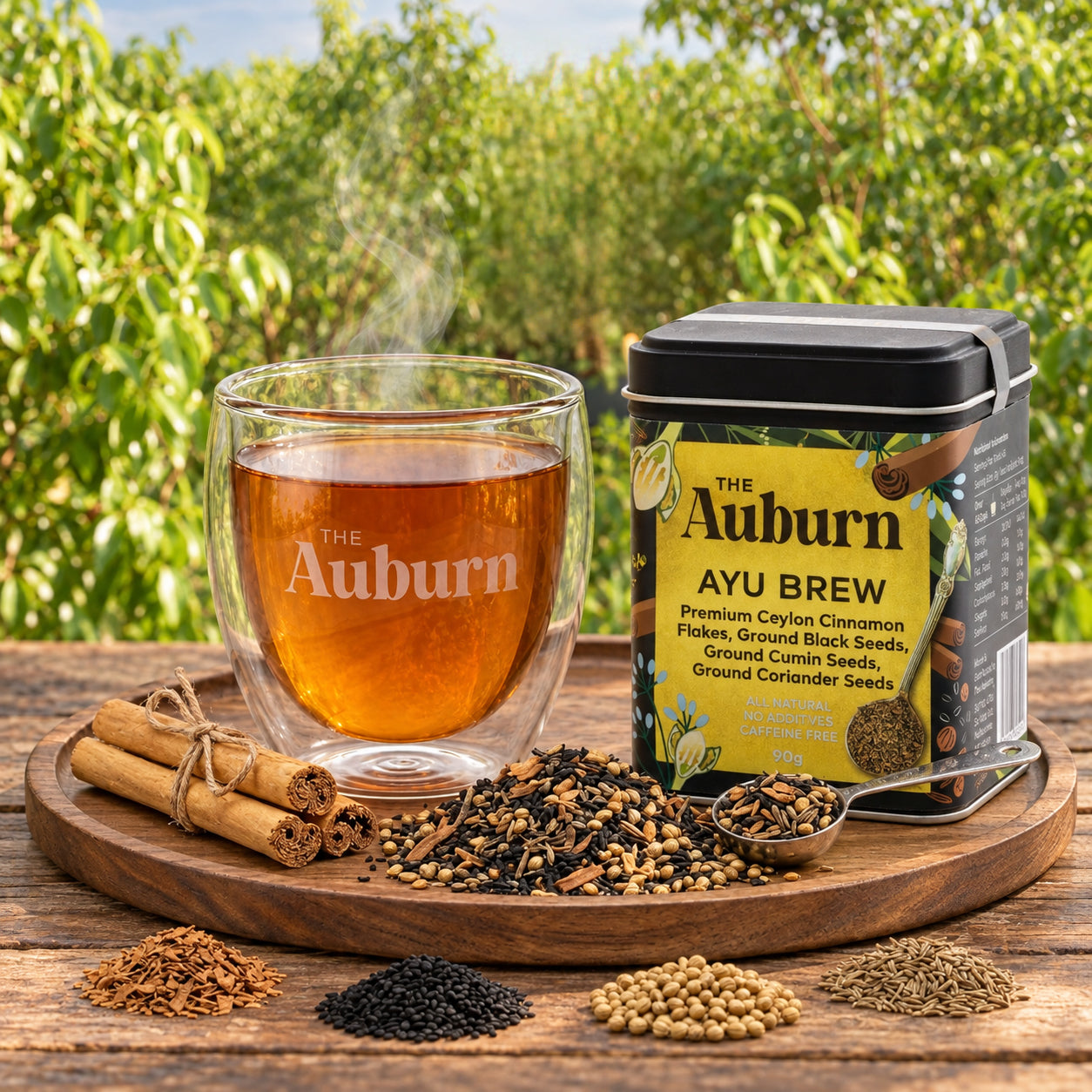 Ayu Brew tin beside a glass cup of brew with black seeds, cumin and coriander on a wooden board