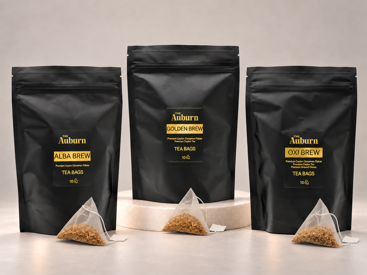 The Auburn tea bag pouches in Alba, Golden and Oxi, each with a pyramid bag of cinnamon in front