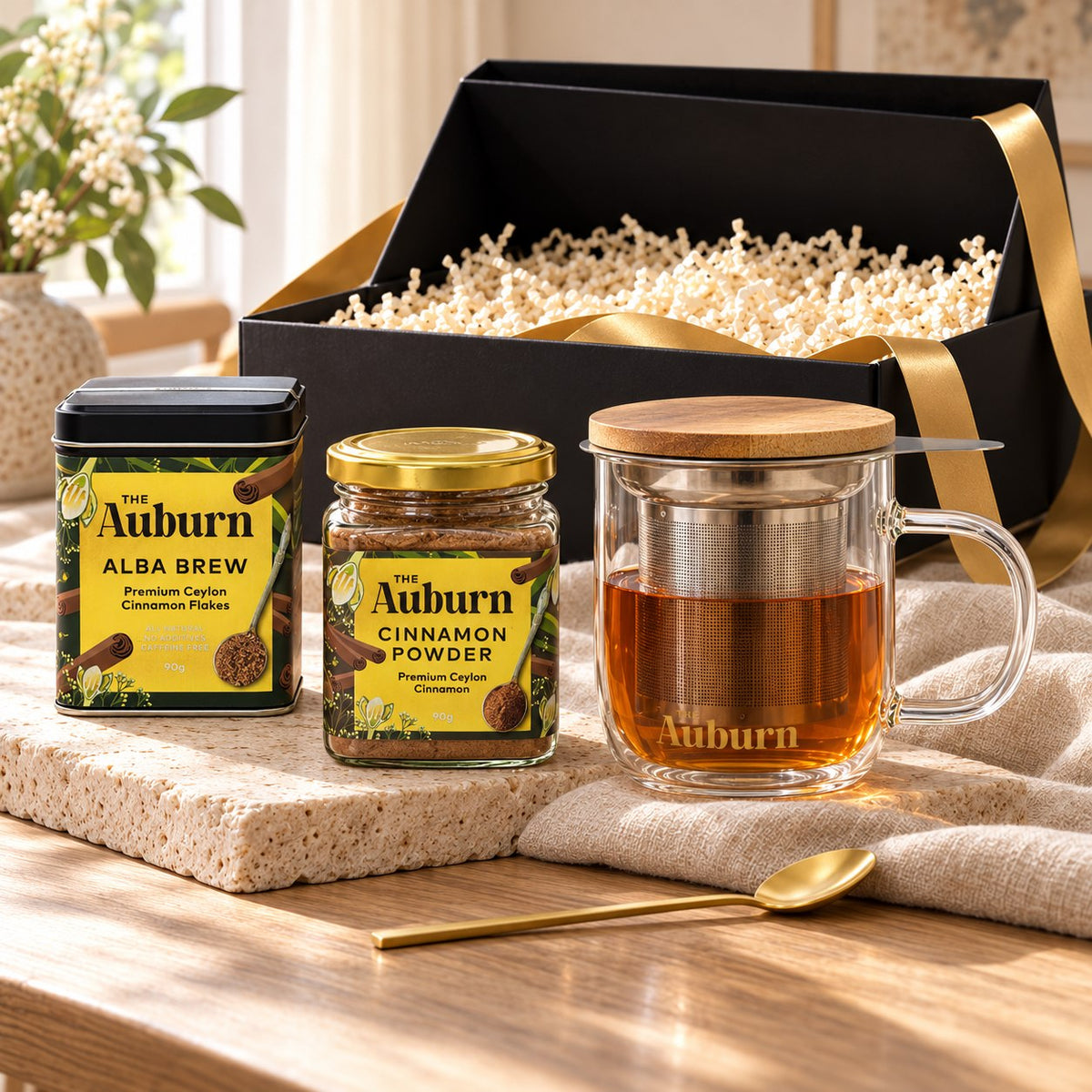 It's all about ME hamper: an Alba Brew tin, a glass brewing mug with strainer, a jar of cinnamon powder and a gold tea spoon.