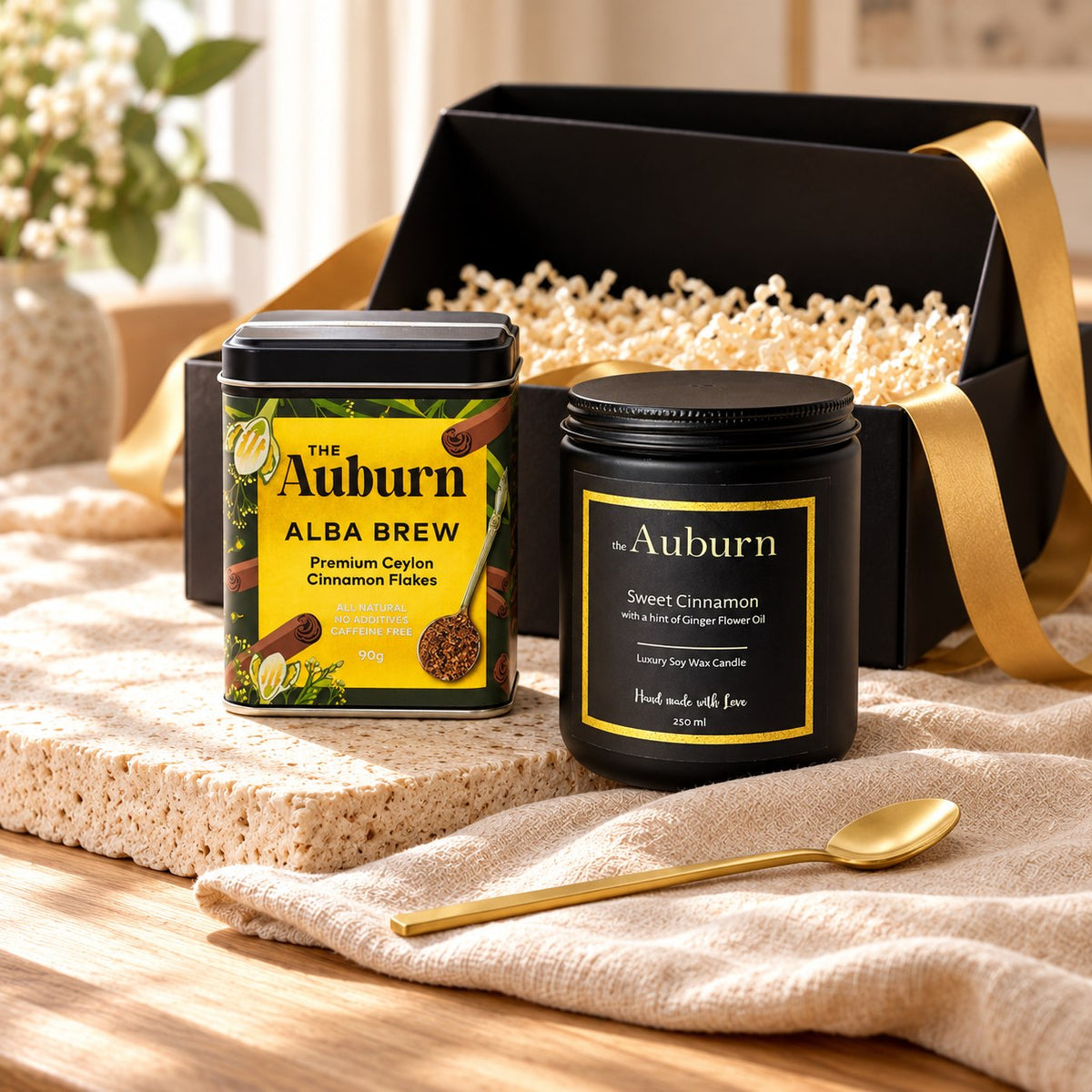 Sweetheart hamper: an Alba Brew cinnamon tin, a black soy wax candle and a gold tea spoon.