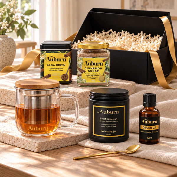 All About Me, Fully hamper: an Alba Brew tin, a glass brewing mug, a jar of cinnamon sugar, a black soy candle, a bottle of diffuser oil and a gold tea spoon.