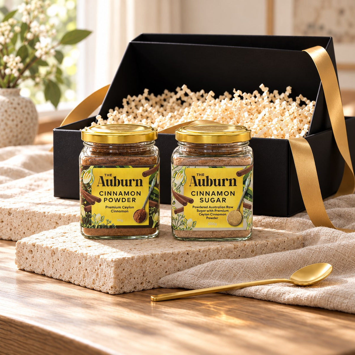 Pantry Starter hamper: a jar of Ceylon cinnamon powder, a jar of cinnamon sugar and a gold tea spoon.