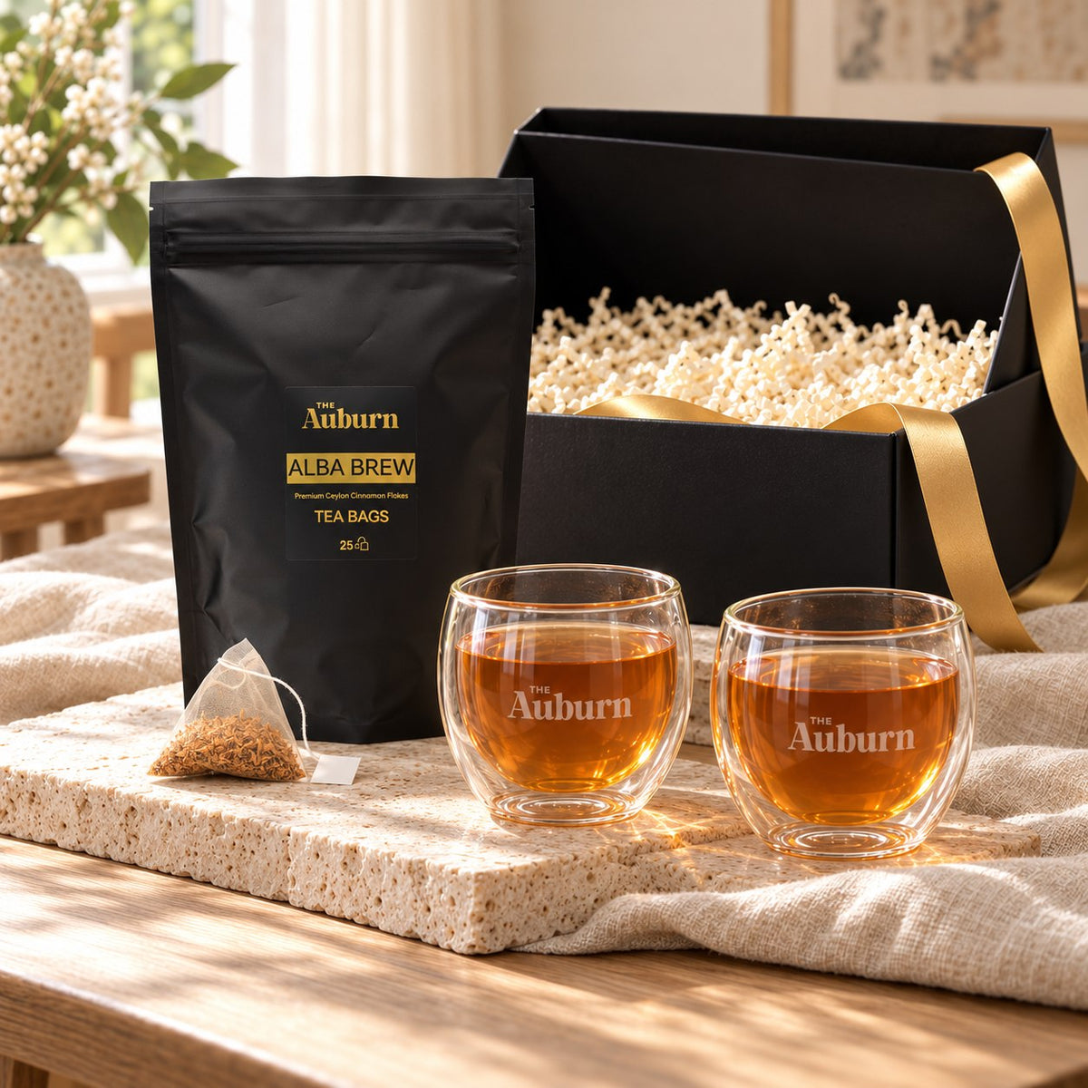Two Cups hamper: a box of Alba Brew tea bags and two double-walled Auburn glass mugs.
