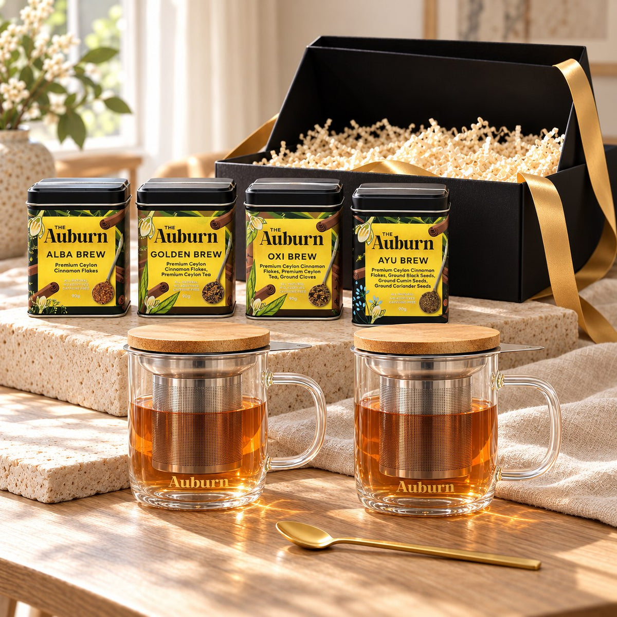 The Master Brewer hamper: Alba, Golden, Oxi and Ayu Brew tins, two glass brewing mugs and a gold tea spoon.