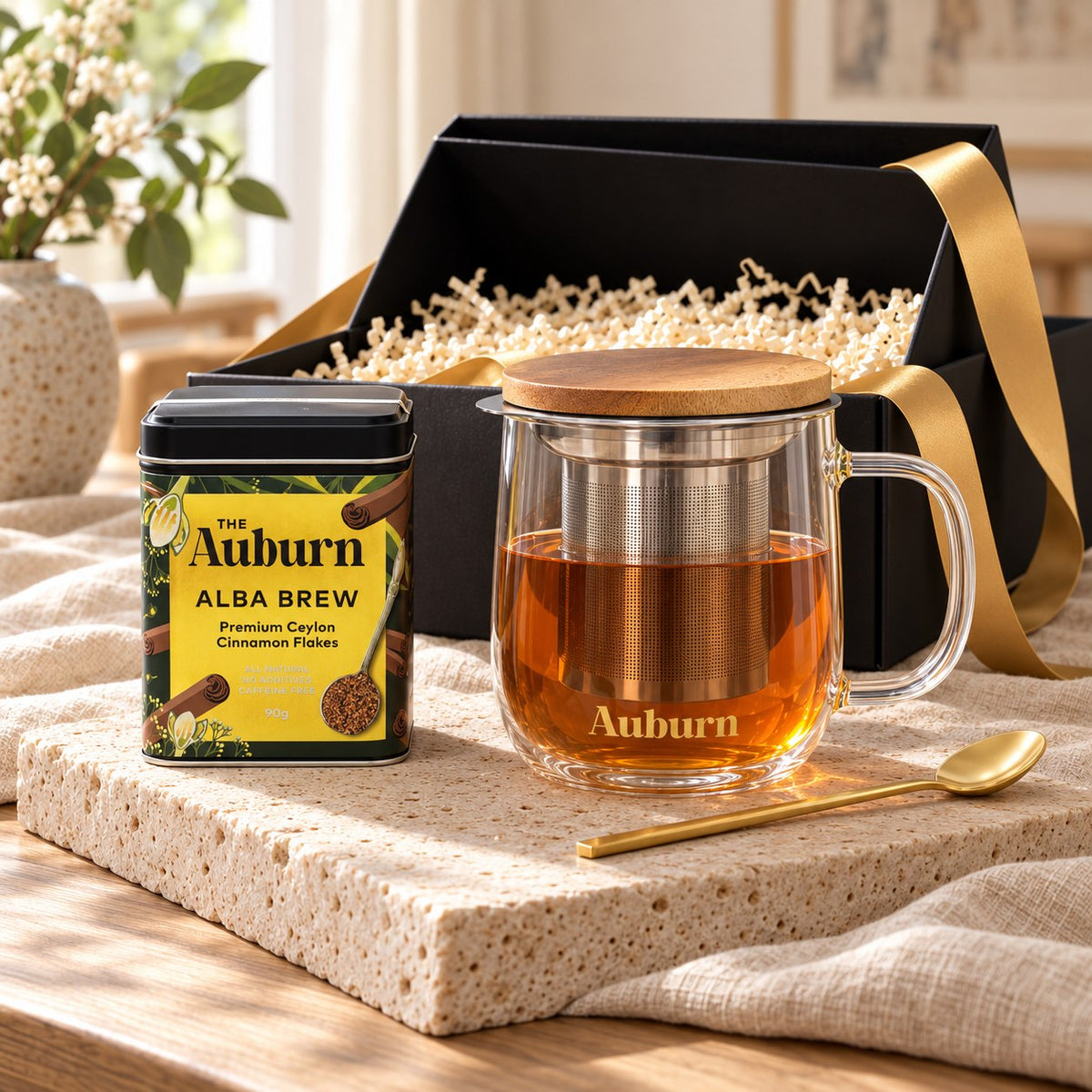 Me Time hamper: an Alba Brew cinnamon tin, a glass brewing mug with strainer and a gold tea spoon.