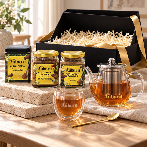 It's a CELEBRATION hamper: an Alba Brew tin, jars of cinnamon honey and powder, a glass teapot, a glass mug and a gold tea spoon.