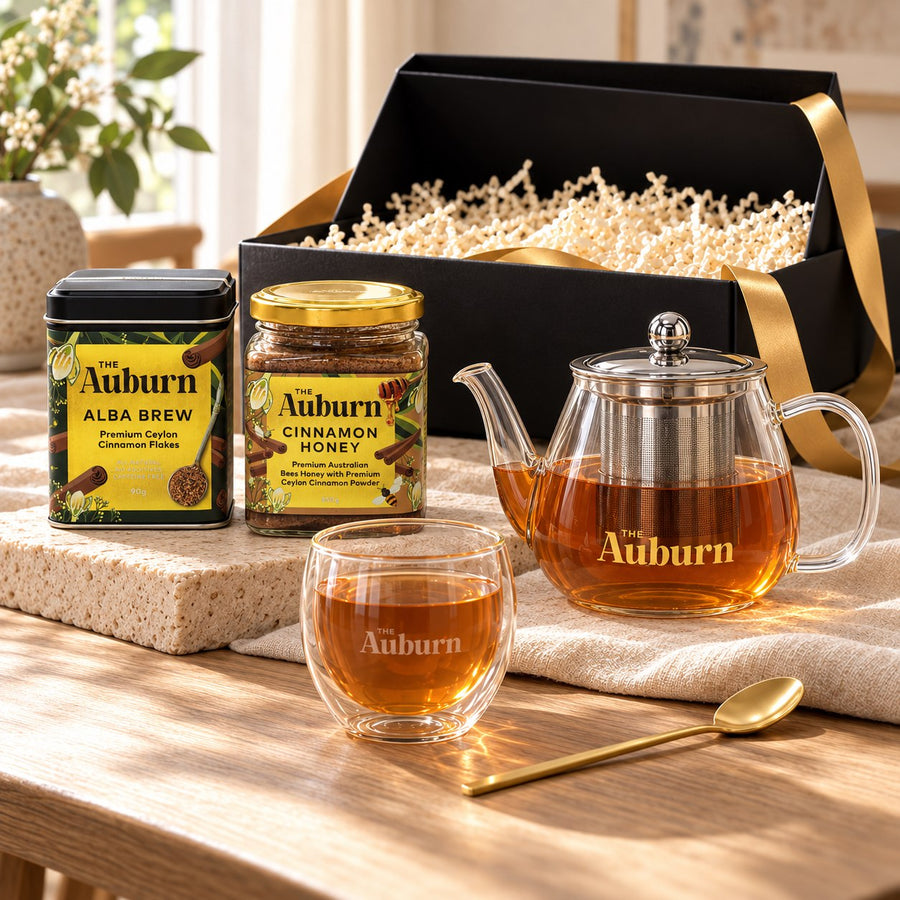 Love is PURE hamper: an Alba Brew tin, a jar of cinnamon honey, a glass teapot, a glass mug and a gold tea spoon.