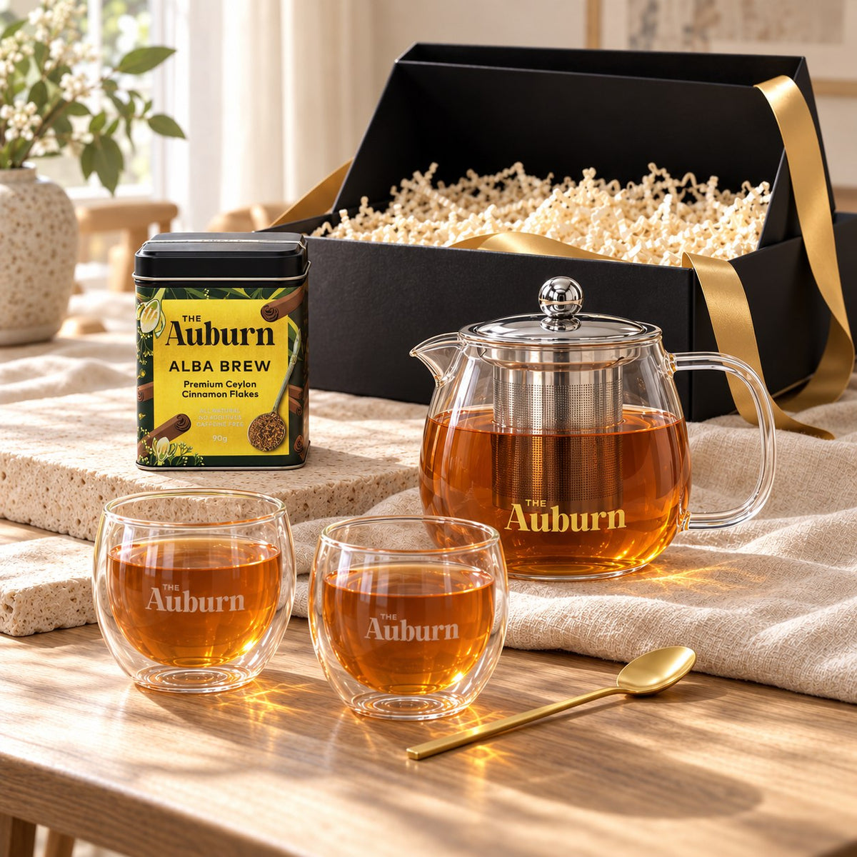 Shared among US hamper: an Alba Brew tin, a glass teapot, two double-walled glass mugs and a gold tea spoon.