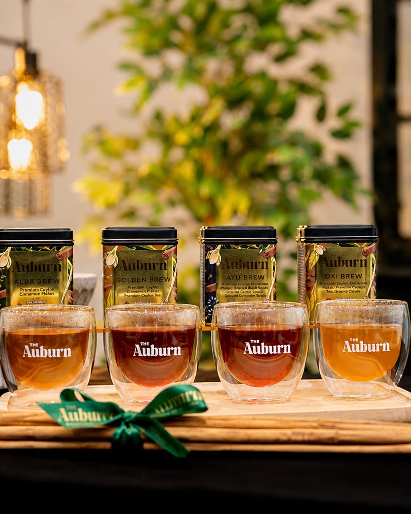Four Auburn brews poured into glasses on a wooden board at a café tasting